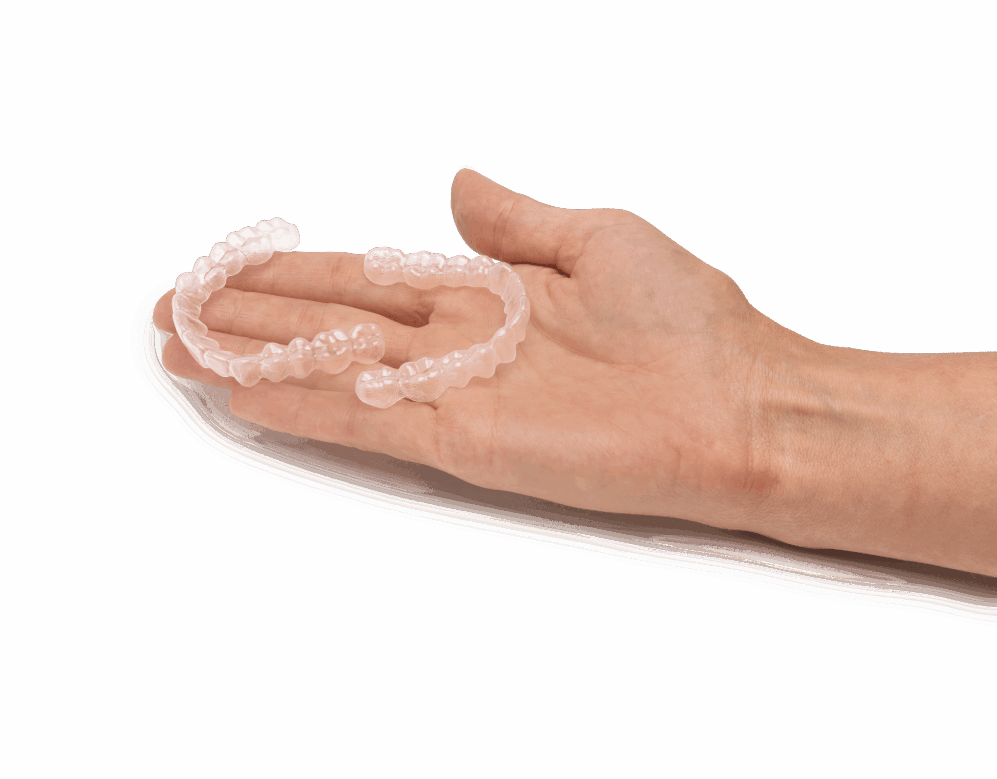 Two clear orthodontic aligners held in a hand on a white background from Angel Aligner, offered by Lenius Orthodontics in Overland Park, KS.