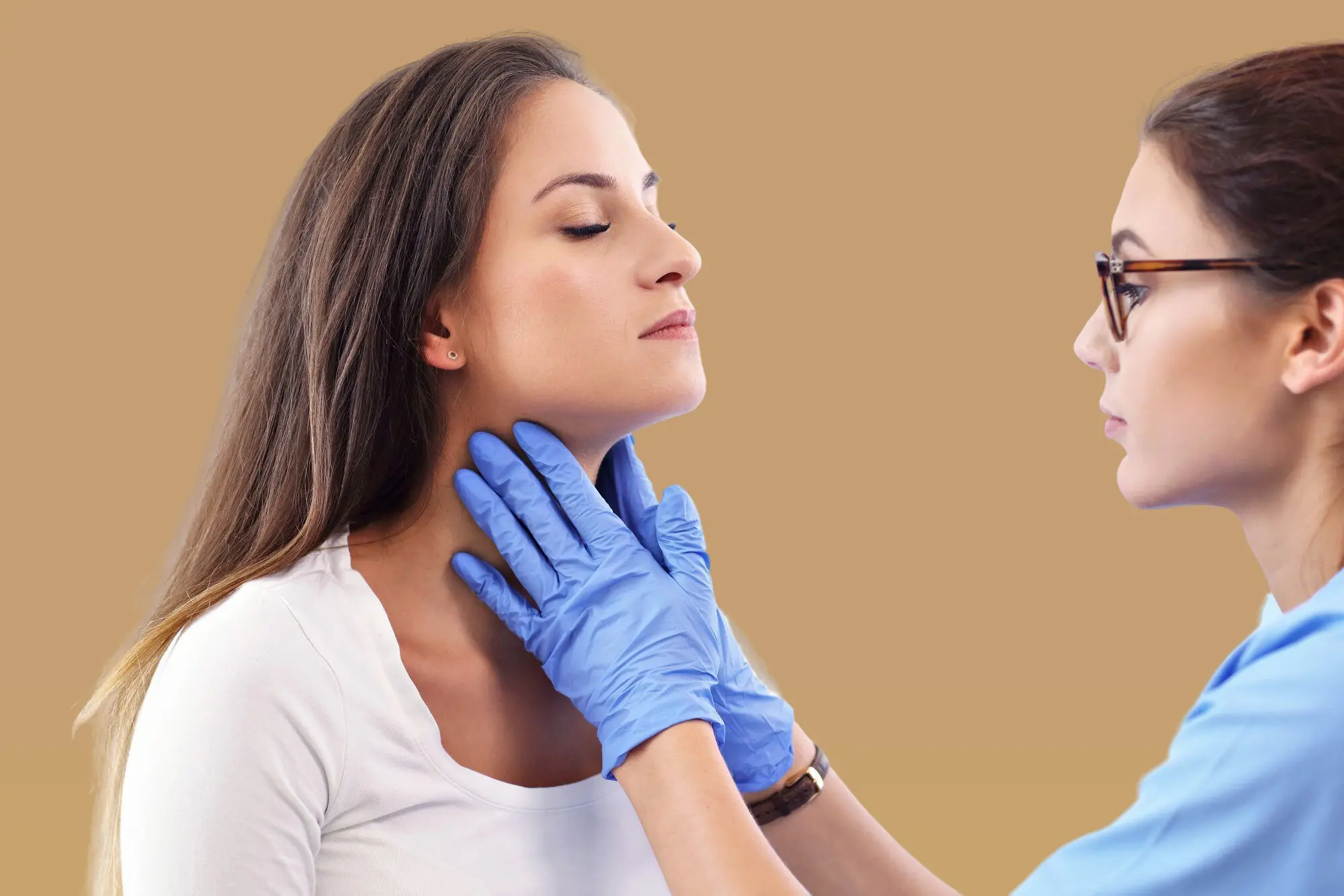 A healthcare professional at Lenius Orthodontics in Overland Park, KS, wearing blue gloves examines a woman's neck after Jaw Surgery.
