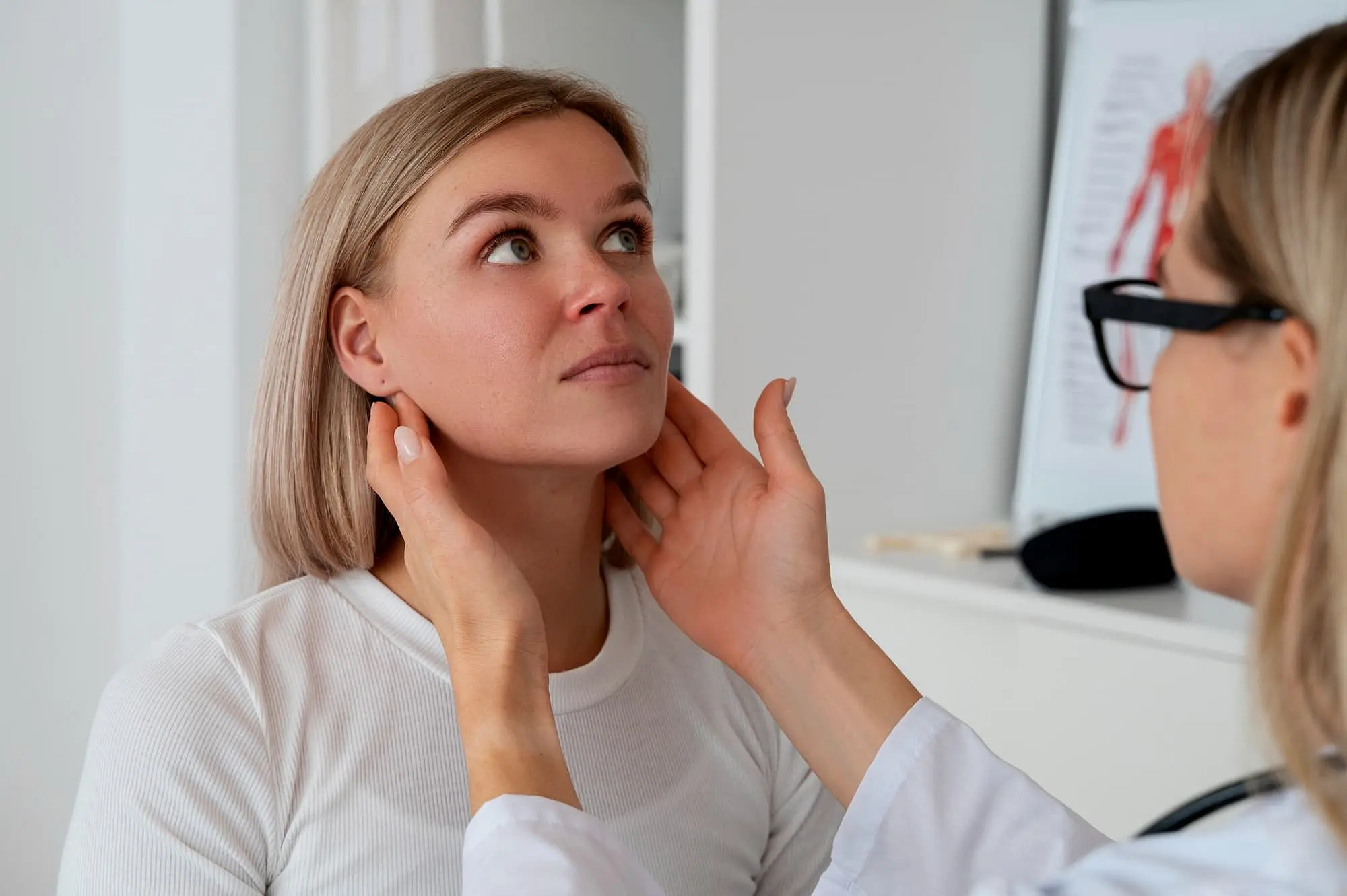 In a Lenius Orthodontics clinic in Overland Park, KS, a healthcare professional check jaw a woman's for physical therapy and rehabilitation after jaw surgery.