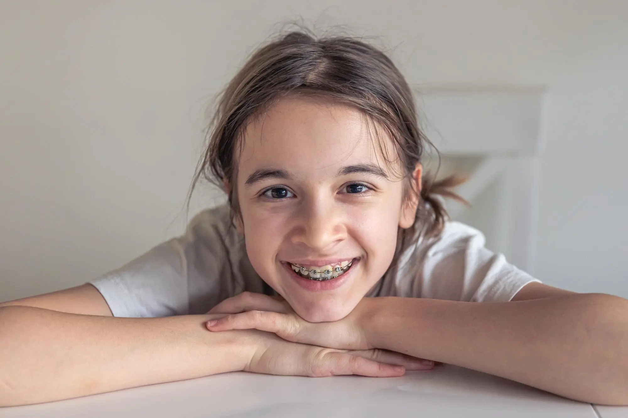 A smiling child with braces from children's orthodontist at Lenius Orthodontics in Overland Park, KS.