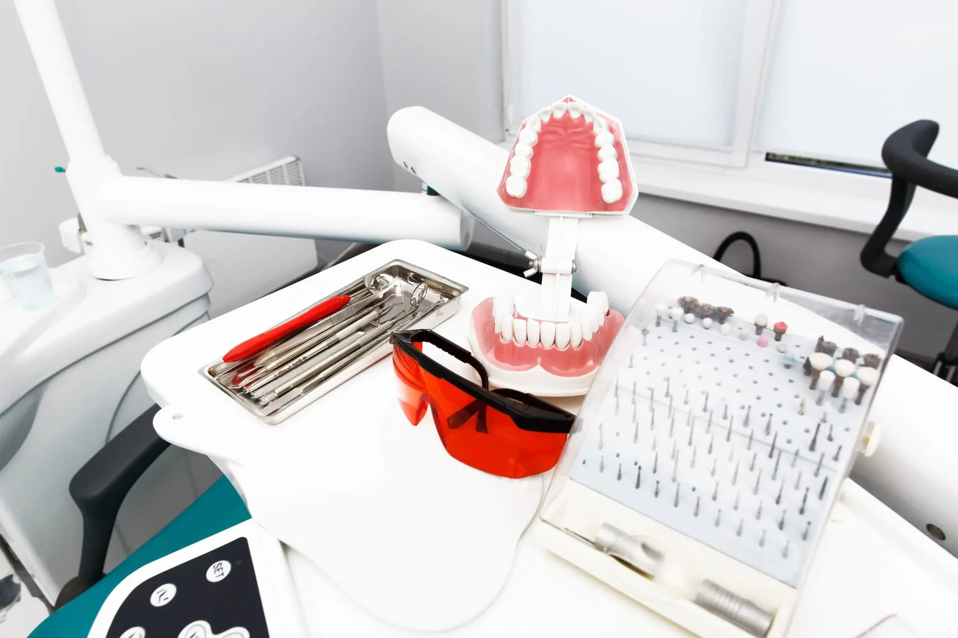 At Lenius Orthodontics in Overland Park, KS, a dental workstation displays braces model, tools tray, glasses, and drills.