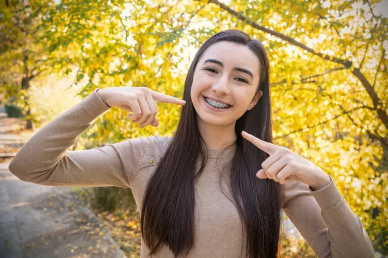 beautiful smiling girl showing metal braces teeth orthodontics dental theme - How Long Do Braces Take in Overland Park, KS