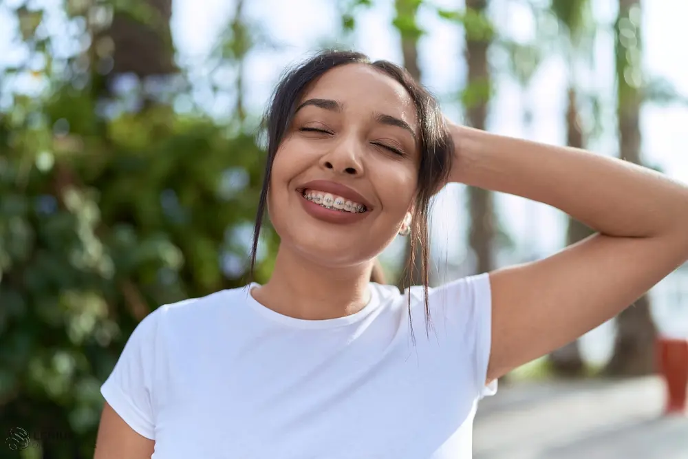 young arab woman with metal braces breathing closed eyes street - How Long Do Braces Take in Overland Park, KS 