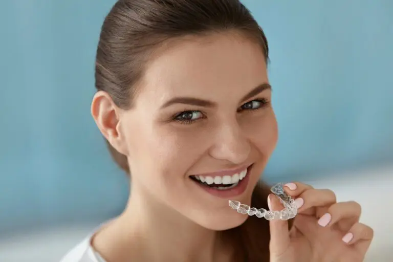 dental care smiling woman using invisalign clear aligners - How Does Invisalign Work in Overland Park, KS